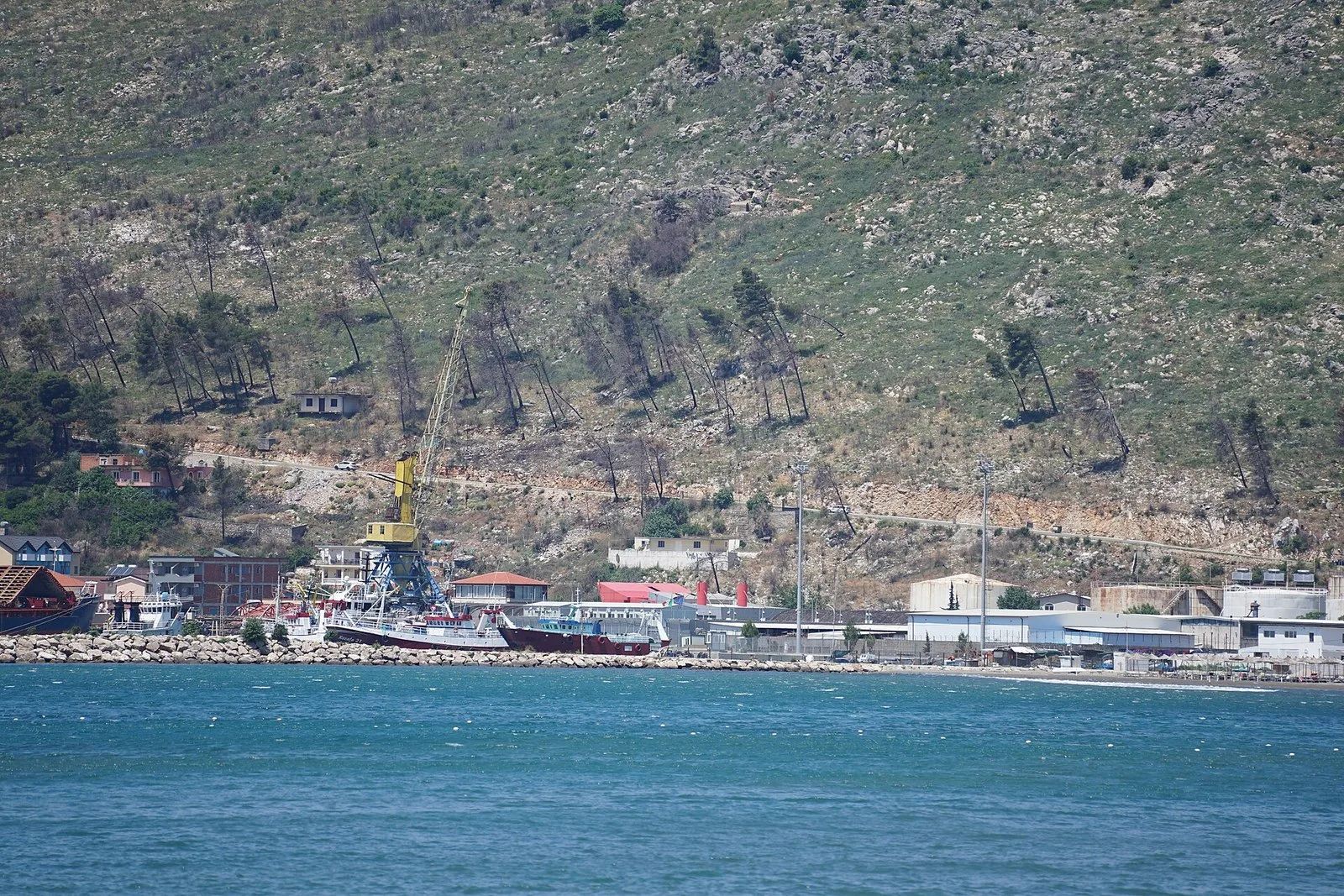 The port of Shëngjin in 2025, with the Italian flag above Italy’s migrant centre