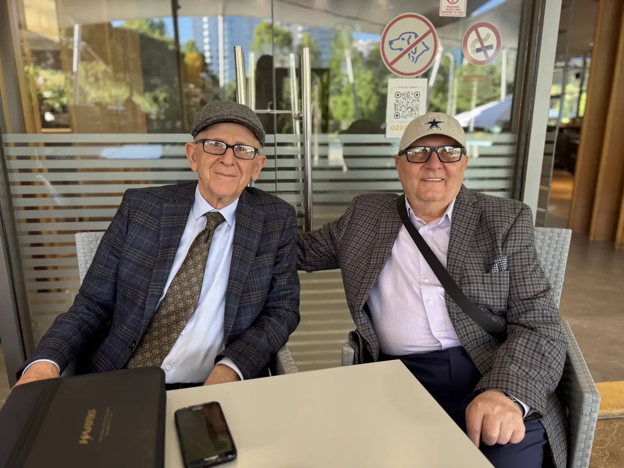 Gani Elezi and Ilia Zhulati sitting in a cafe